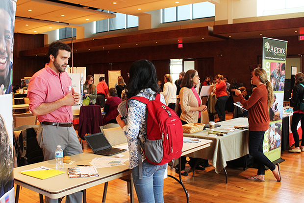 A student chats with an organization representative at the 2017 spring fair