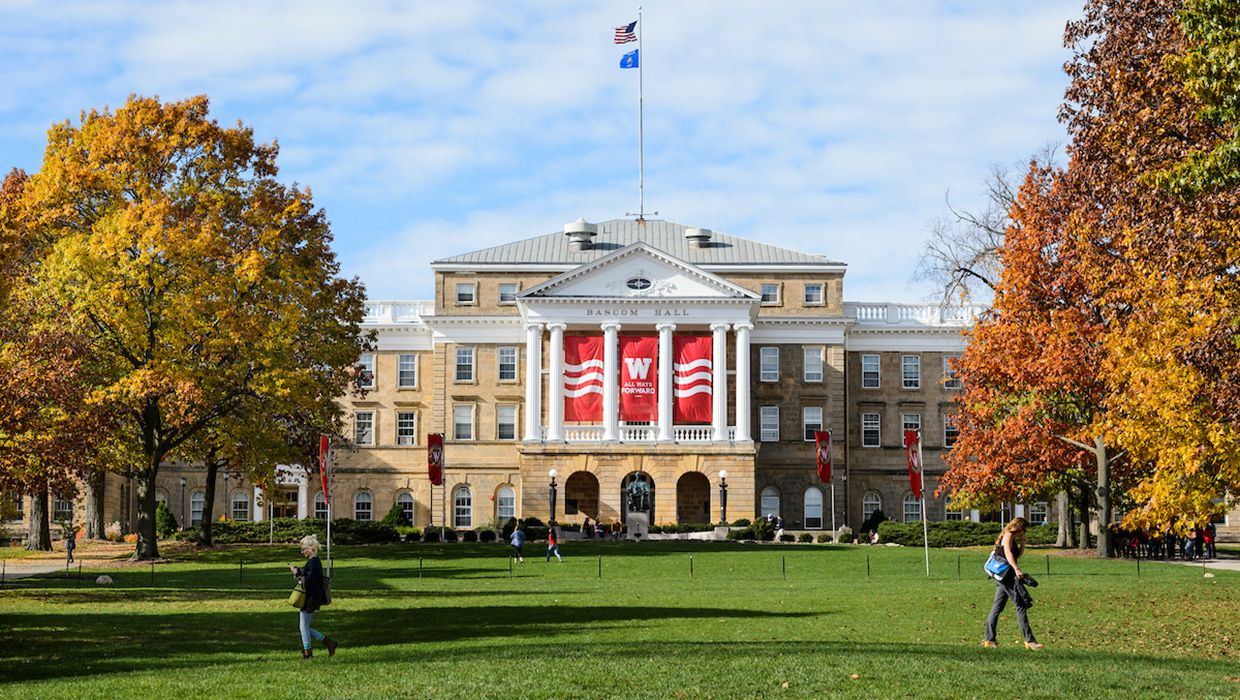 Pedestrians and students walk across Bascom Hill