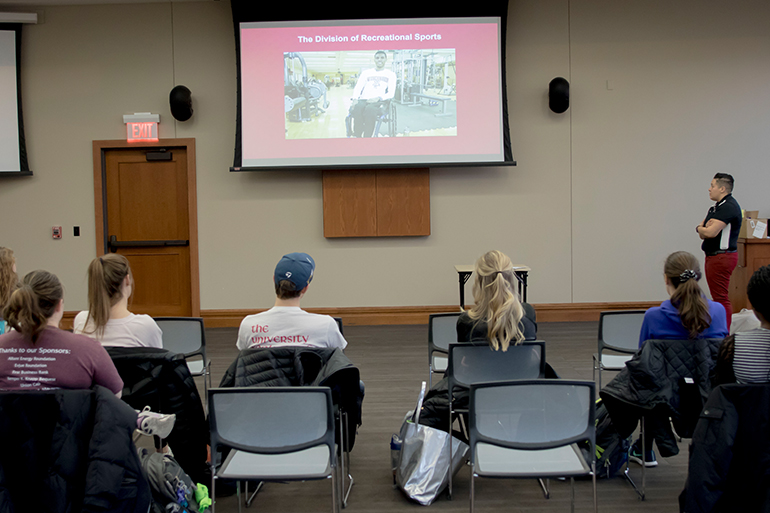 Coordinator of Competitive Sports Tori Landron shows UW-Madison students a video on Badgers ADAPT.