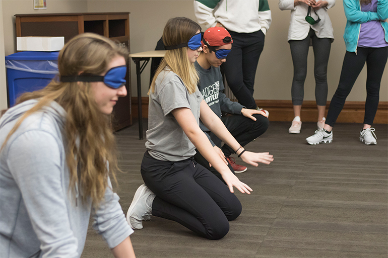 The third activity of the night, Goalball. Students await to catch a ball thrown by the opposing team.