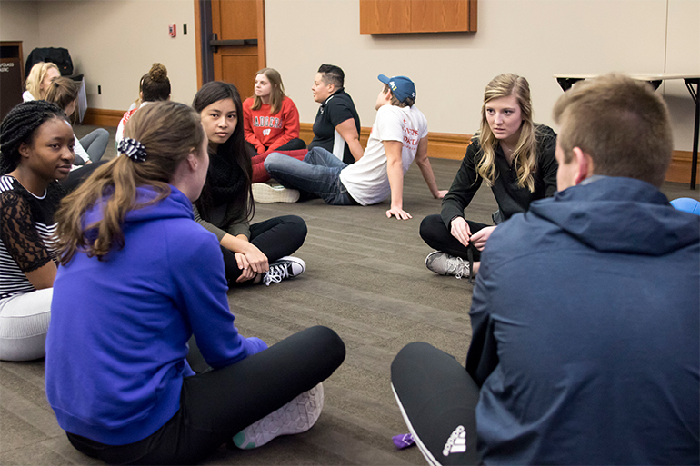 Students gather together to reflect and discuss after each activity.