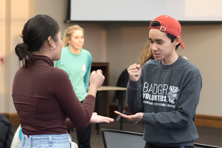 Students engage in Rock-Paper-Scissors as the event's first activity.