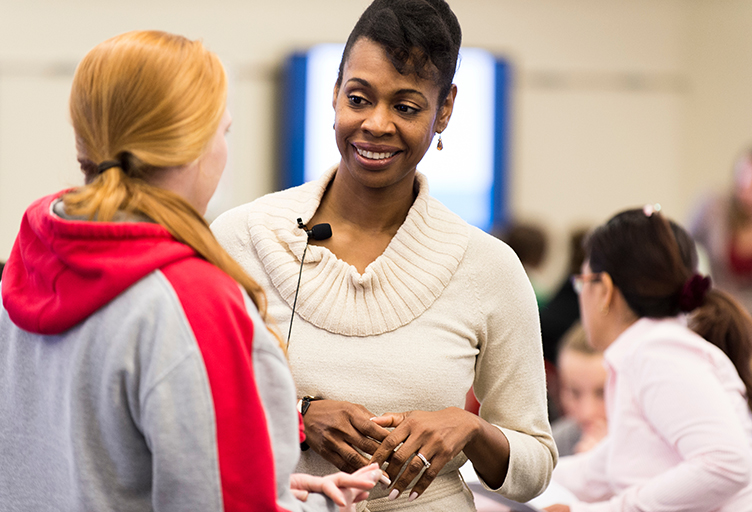 Associate Professor Earlise Ward, right, talks with a student during a break co-teaching a section of N310: Mental Health and Mental Illness, a School of Nursing class taught in the Active Learning Classroom (ALC) in Signe Skott Cooper Hall at the University of Wisconsin-Madison on Oct. 22, 2014. The interactive classroom features clustered seating and state-of-the-art computing and audio-visual technology as tools for student engagement. (Photo by Jeff Miller/UW-Madison)