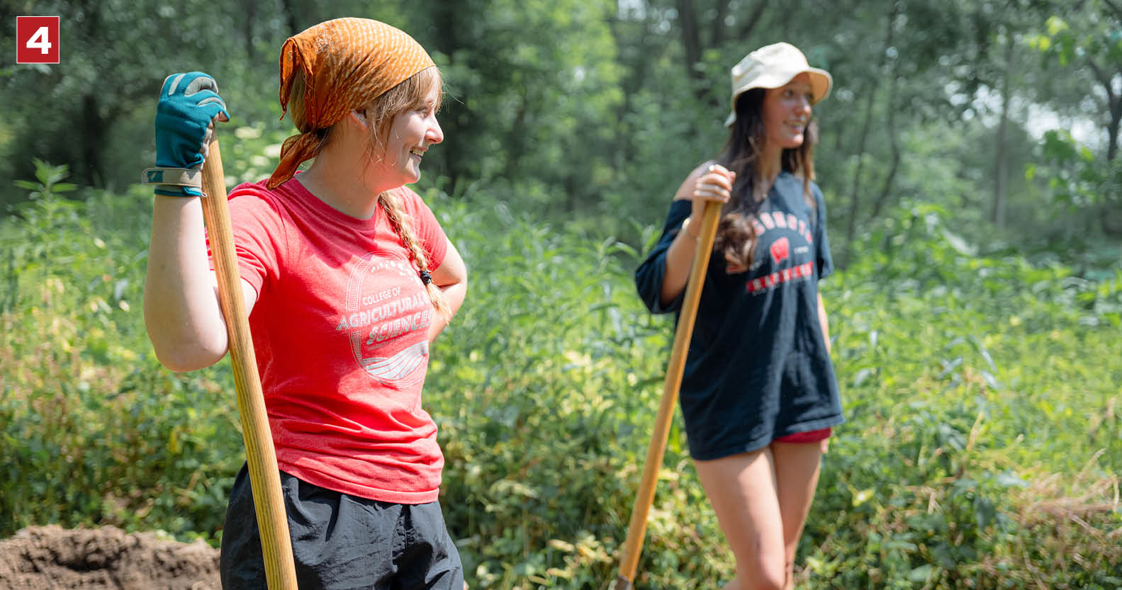 Madeline Vukovich (left) and Rachel Lichter (right) shoveling dirt at the Linda Gene & Farley Center.