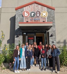 A group of students standing in front of Brix Cider