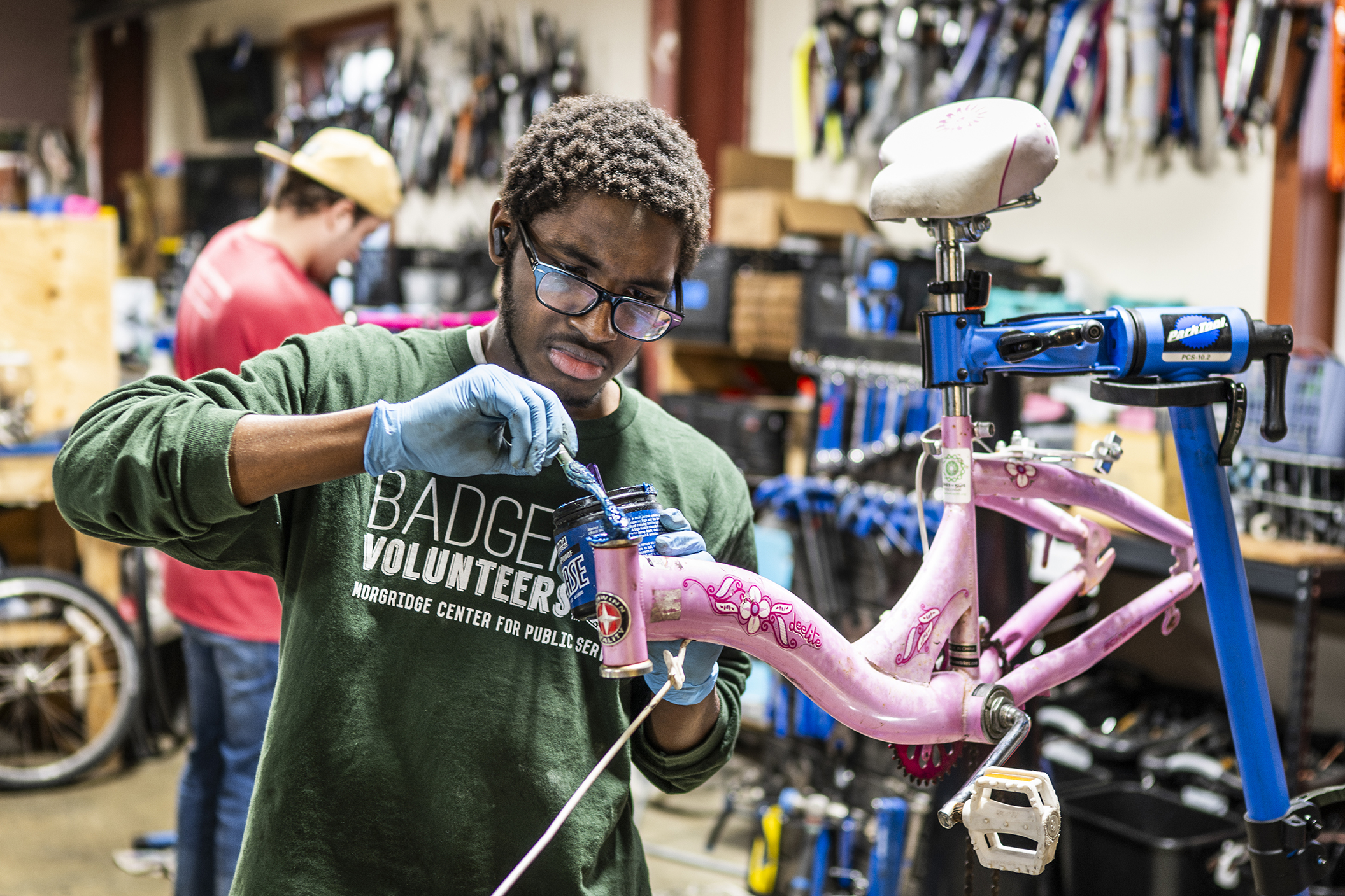 First-year electrical engineering major Kebba Jammeh joins Bike for Kids in refurbishing donated bicycles for people in the Dane County facing financial instability in a workshop in Madison, Wisconsin on March 9, 2026. Bikes for Kids is partnered with Badger Volunteers (BV), a semester-long program that pairs teams of students with community organizations to volunteer 1 to 4 hours each week at the same organization. Kebba Jammeh says he volunteers for Bikes for Kids because “ I love the bike community. I also love being able to give more kids and adults the opportunity to use bikes to whatever they need it, for transportation, having fun, or enjoying the weather.” (Photo by Taylor Wolfram / UW–Madison)