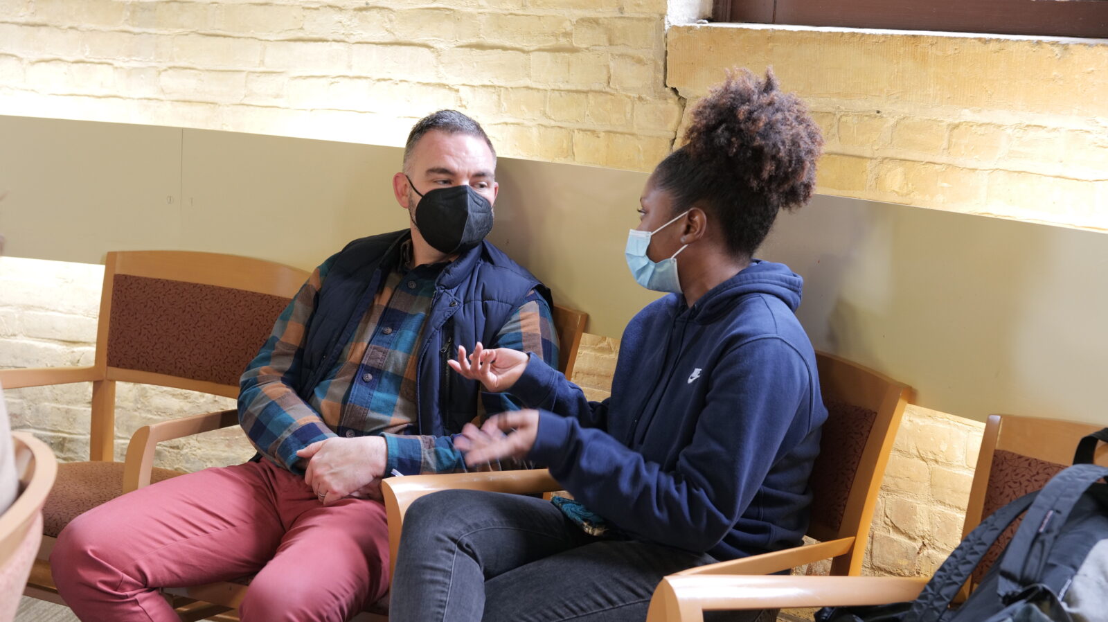 Dr. Travis Wright talking to Operations Intern Saffiatu Barrie during a Morgridge Center game night event in March 2022.